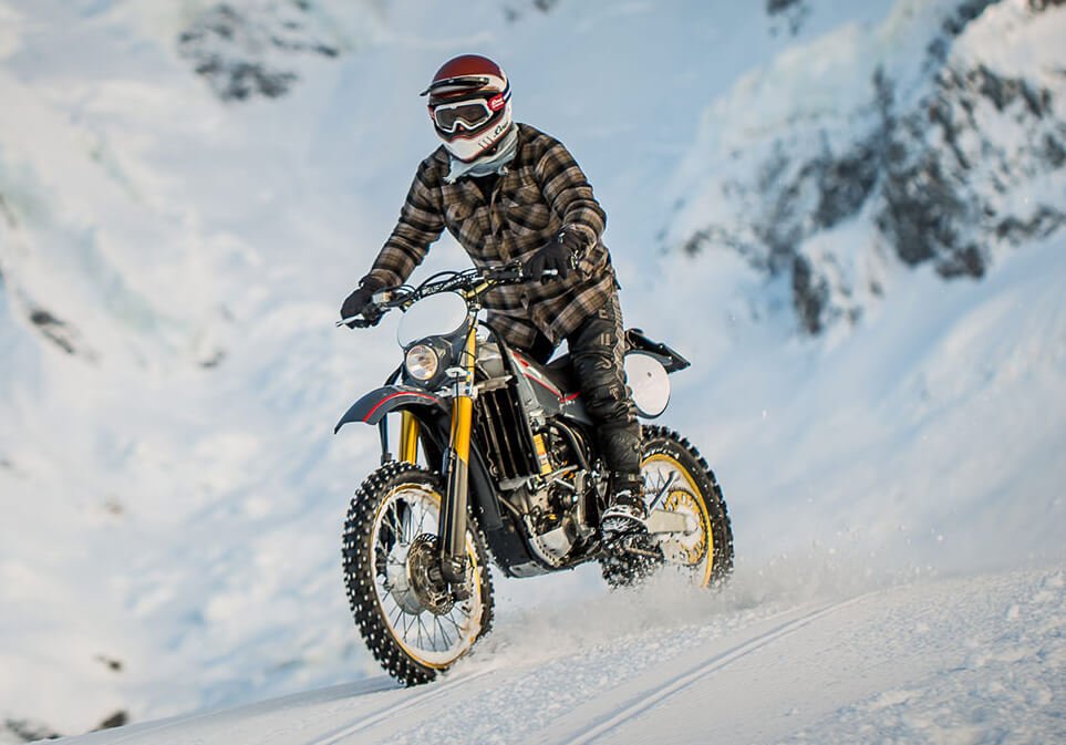 a man is riding a Yamaha WR450F on the snow - best motorcycle for snow and ice options