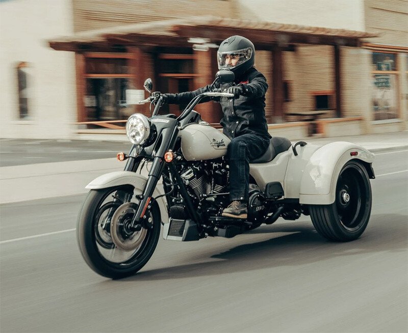 three wheel trike motorcycle riding in city road