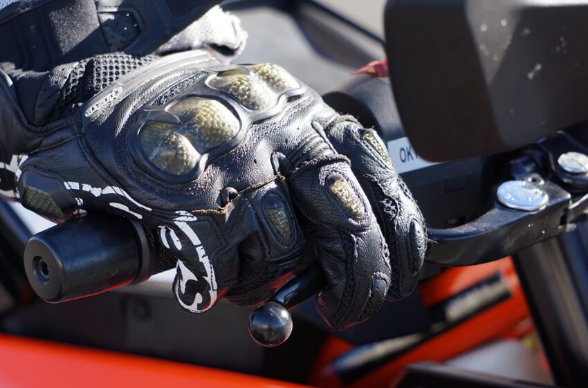 keep your fingers over the brake levers while riding a motorcycle in heavy traffic
